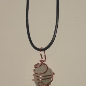 Chloride quartz crystal inclusion wrapped in copper with leather cord